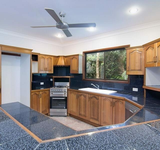 tiled kitchen with wooden cupboards